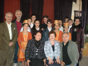 Maro Bedrosian, seated center, with Karabagh School Principal Anahid Kossagyan, Detroit ADL Chairman Hagop Alexanian, students and guests