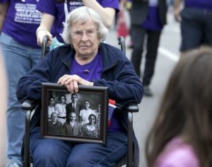Lola Manoogian carries a photo of her husband an family as she and a crowd march up Guadalupe Street toward the Capitol in Austin, Tx., to commemorate and raise awareness about the 100th anniversary of the Armenian genocide in Turkey on Saturday, April 18, 2015. DEBORAH CANNON / AMERICAN-STATESMAN