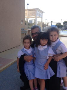 Archbishop Moushegh Mardirossian  with young sduents