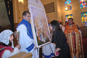 Alina Kouzouian, kissing the Icon of the Holy Martyrs at the conclusion of the Consecration Service.