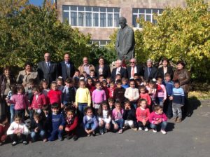 TCA members from US, Canada, England and Greece in front of the bust of Vahan Tekeyan with students of Garpi School