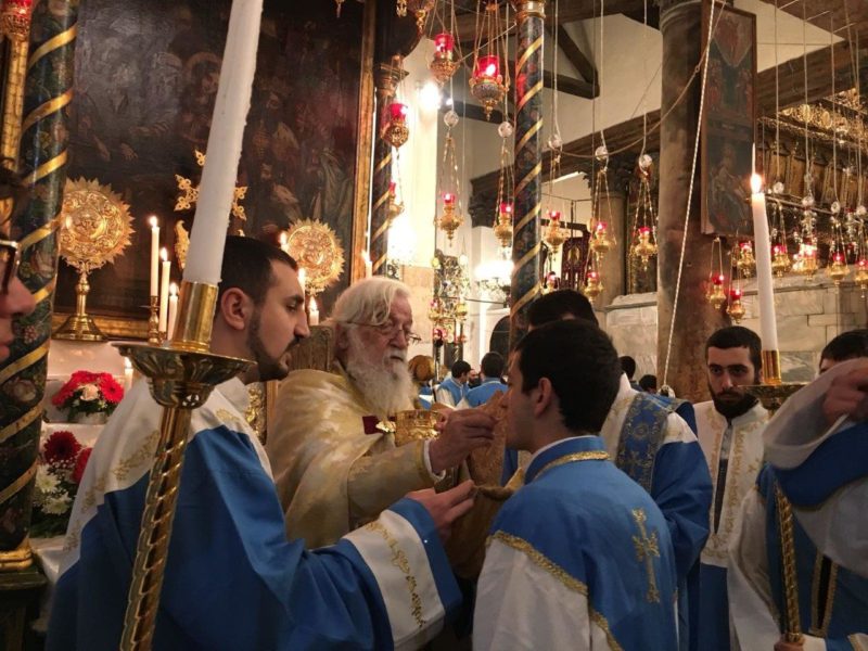 Archbishop Sevan Gharibian, Canon Sacristan, giving communion in Bethlehem on Armenian Christmas Eve (January 18).