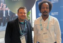 Jonathan Spangenberg, left, with Teklehaymanot Weldemichel, another attendee