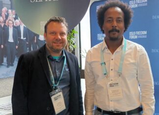 Jonathan Spangenberg, left, with Teklehaymanot Weldemichel, another attendee