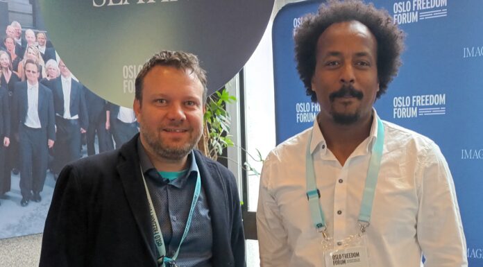 Jonathan Spangenberg, left, with Teklehaymanot Weldemichel, another attendee