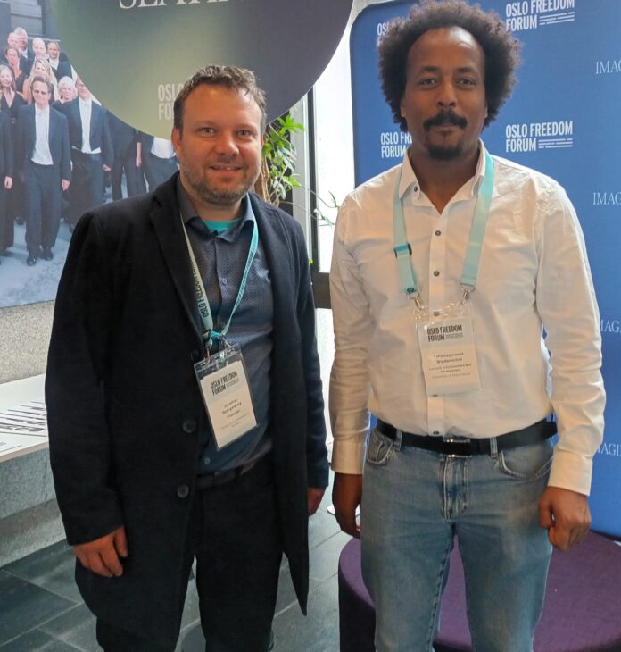 Jonathan Spangenberg, left, with Teklehaymanot Weldemichel, another attendee